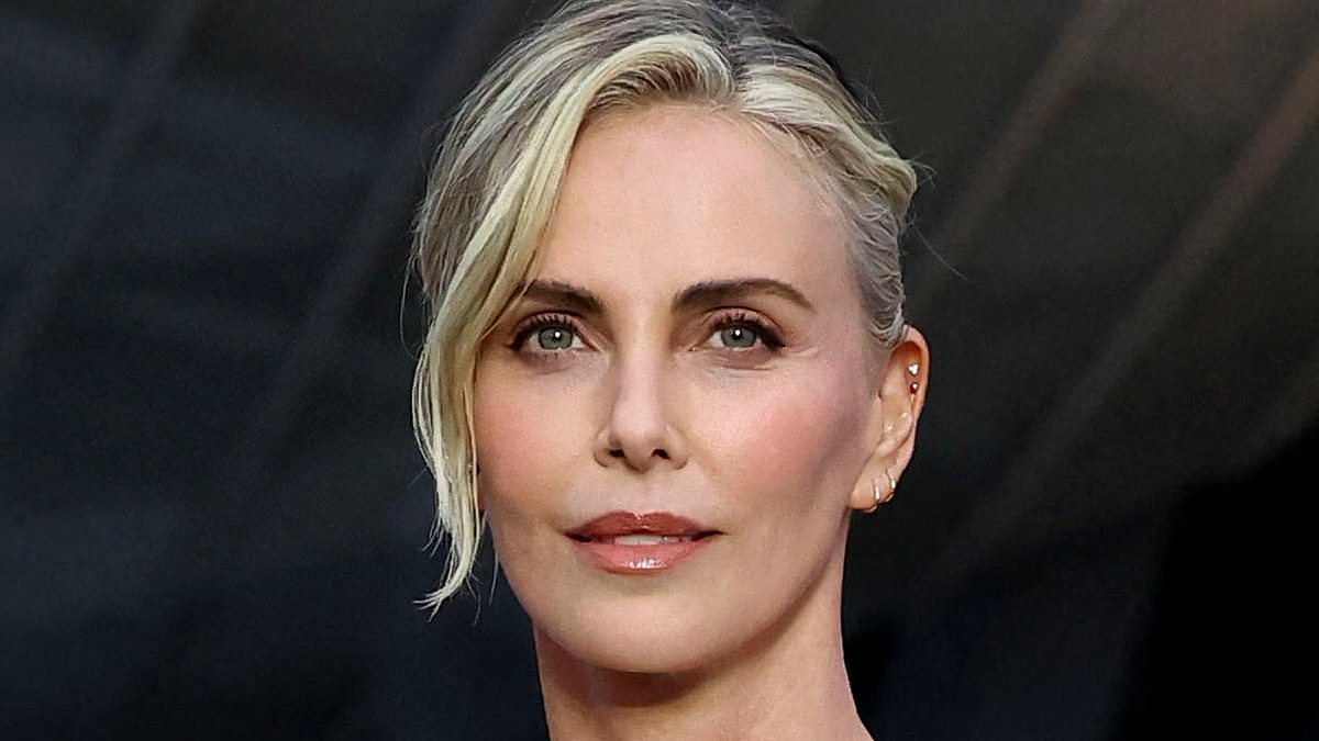 Charlize Theron turns heads in white minidress with dramatic one-shoulder sleeve at Louis Vuitton's Prelude to the Olympics star-studded soiree in Paris